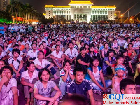 On October 1, 2009, migrant workers watched the National Day military parade on TV in the square.