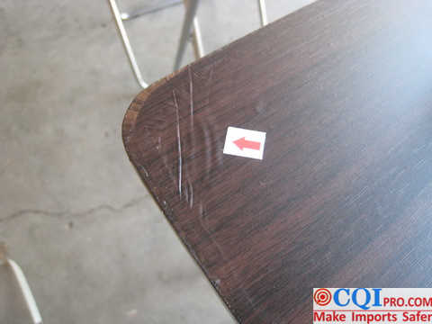 Folding table inspection in a Chinese furniture factory - 100% of the sampled products had uneven veneer edges.