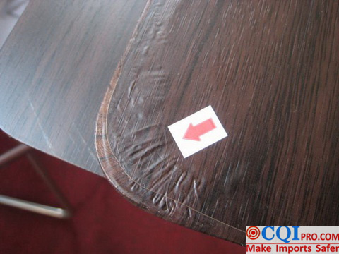 Folding table inspection in a Chinese furniture factory - 100% of the sampled products had uneven veneer edges.