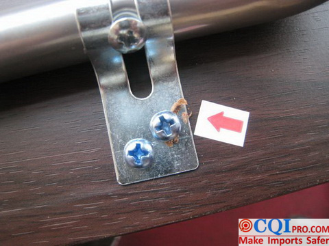 Folding table made in China furniture factory - screws surrounded by foreign objects