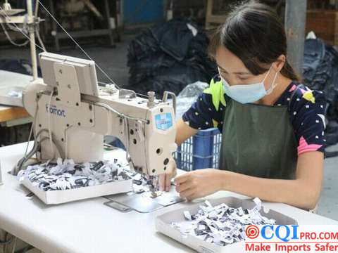 Workers sewing Jeanswear in factory