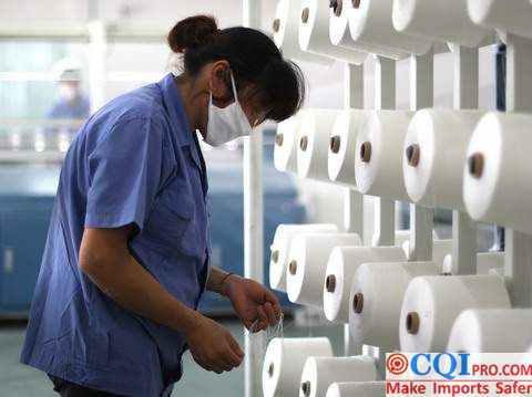 Workers check the textile threads in the pajamas factory.