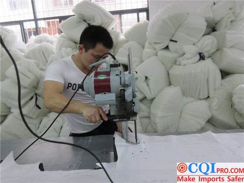 Chinese garment pattern maker cutting out a pattern